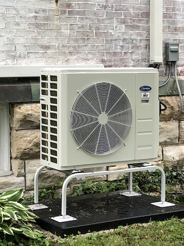 photo of residential minisplit installation shown by house exterior